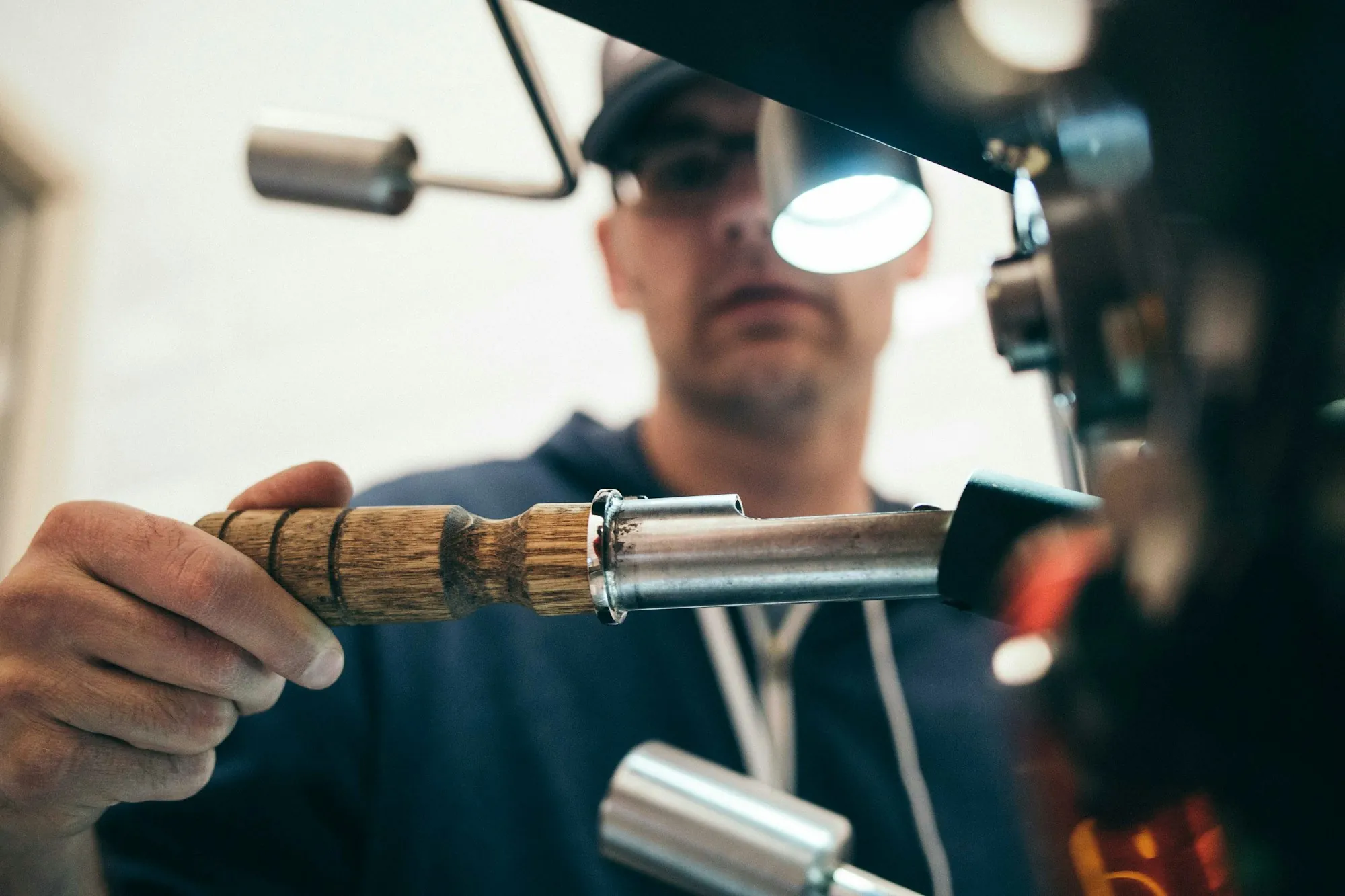 A technician working on household plumbing with hand tools