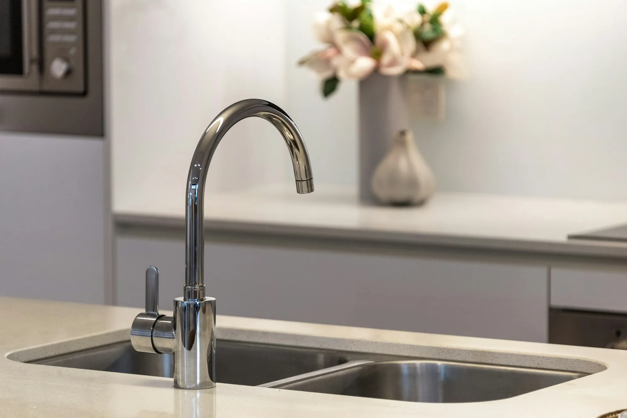 A clean kitchen with a stainless faucet and double sink