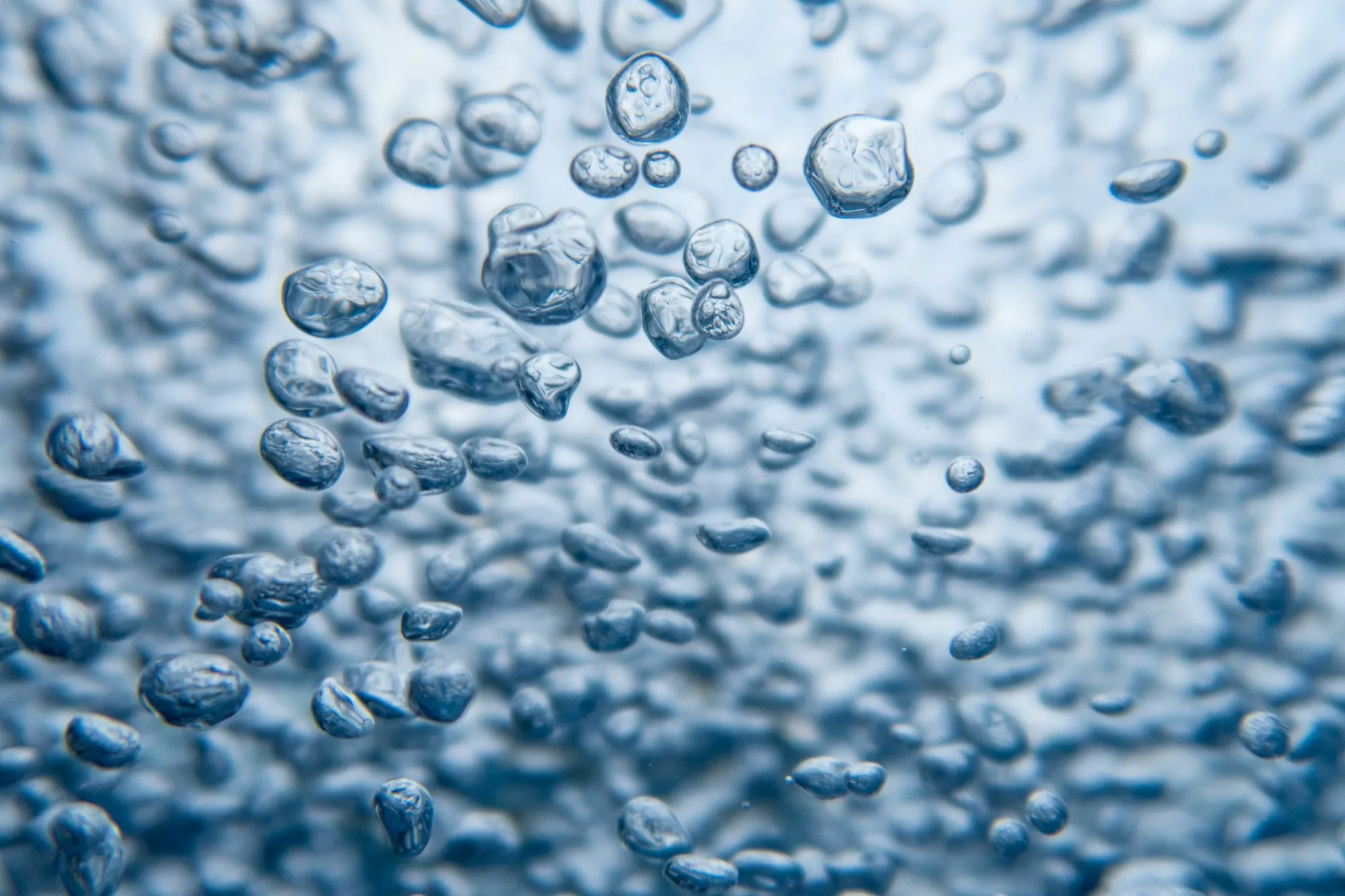 Close view of clear water full of small rising bubbles