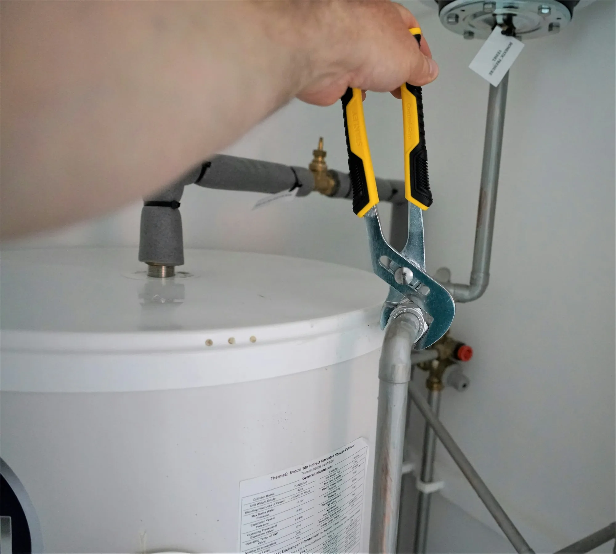 A water softener tank being connected to a home's supply line